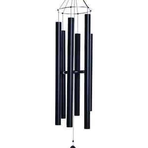 May include: Black metal wind chime with multiple tubes hanging from a circular frame. The chime has a black stone-shaped clapper.