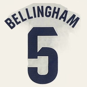 May include: A white jersey with a navy blue name and number. The name "BELLINGHAM" is arched above the number "5".