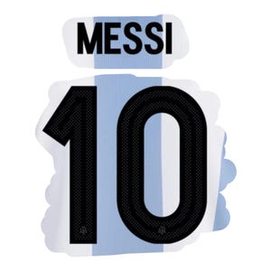May include: A sticker featuring the name "MESSI" above the number "10" in black, set against a light blue and white striped background, reminiscent of a soccer jersey. The design is outlined with a white border.