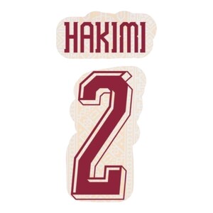 May include: A maroon and white sticker set featuring the name "HAKIMI" above the number "2". The text and number have a bold, outlined design. The background has a subtle, patterned texture.