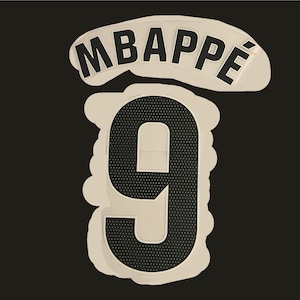 May include: A white and black iron-on patch with the name "MBAPPÉ" and the number "9" in black.