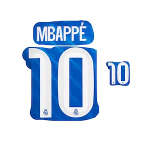 May include: Blue and white graphic of a soccer jersey with the name "MBAPPÉ" above the number "10". The number is large and centered, with a smaller version to the right. The design includes the team logo.
