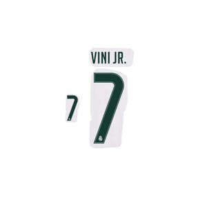 May include: A set of dark green iron-on transfers featuring the text VINI JR. and the number 7 in a bold font. The large number 7 includes a small Real Madrid club crest at the base, accompanied by a separate, smaller number 7 decal.