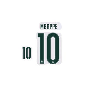 May include: A set of dark green iron-on transfers featuring the name MBAPPÉ and the number 10 in a bold, block font. The number 10 includes a small, circular Real Madrid club crest logo at the base of each digit, presented on a white background.