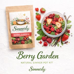 May include: A brown paper bag labeled "Simmerly Berry Garden" with a colorful illustration of a pot and berries. A glass bowl filled with berries, strawberries, and mint leaves sits next to the bag. The words "Berry Garden" and "Natural Simmer Pot Kit" are displayed.