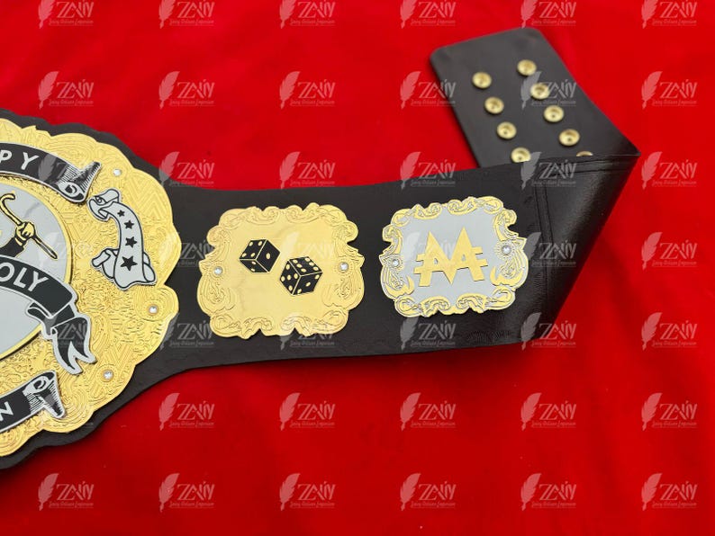 May include: A black leather championship belt with gold and silver accents. The belt features a large, ornate buckle with the word "MONOPOLY" and a dice design. There are two smaller plates on the belt, one with a dice design and the other with the letters "AA".