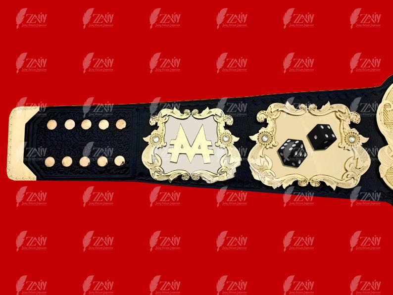 May include: A black and gold championship belt with a large, white, ornate plaque featuring the letter "A" with two dollar signs. The belt also has a smaller plaque with two black dice.