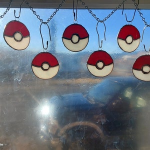 stained glass sun catcher, cartoon themed, anime style, got to catch them all balls