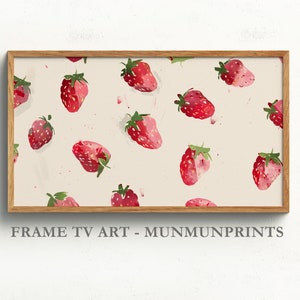 Peut inclure: Une impression encadrée avec un fond blanc et un motif répété de fraises rouges. Le texte "FRAME TV ART - MUNMUNPRINTS" est en bas de l'impression.