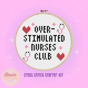 May include: A cross stitch starter kit featuring a white hoop with the text "OVER-STIMULATED NURSES CLUB" in black, surrounded by pink and red hearts and a grey stethoscope.