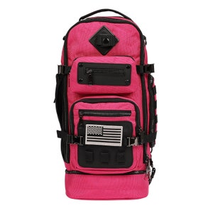 May include: A pink backpack with black straps and accents. It has multiple pockets and a small American flag patch on the front.