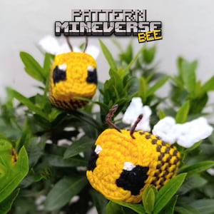 May include: Two handmade crochet bees with yellow and black bodies, white wings, and brown antennae, nestled among green leaves. The bees are in a Minecraft style. The text "PATTERN MINEVERSE BEE" is at the top.