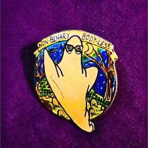 May include: A yellow ghost with glasses and the text "Non-Binary Body-Less" in a colorful circular frame.