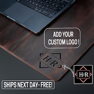 May include: A brown leather desk mat with a laptop on top. The mat has a custom logo design and the text "ADD YOUR CUSTOM LOGO!". The text "SHIPS NEXT DAY - FREE!" is also visible.