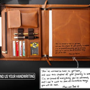 May include: Open leather portfolio with multiple compartments, including pen holders, card slots, and a larger pocket for documents. The portfolio is a warm brown color and features a handwritten message. The text on the portfolio says "SEND US YOUR HANDWRITING".