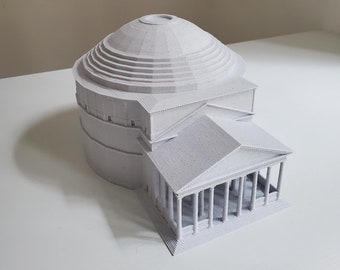 May include: A white 3D printed model of the Pantheon in Rome. The model is detailed and includes the dome, columns, and steps.