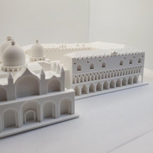 May include: A white 3D printed model of a building with a domed roof and a colonnade.