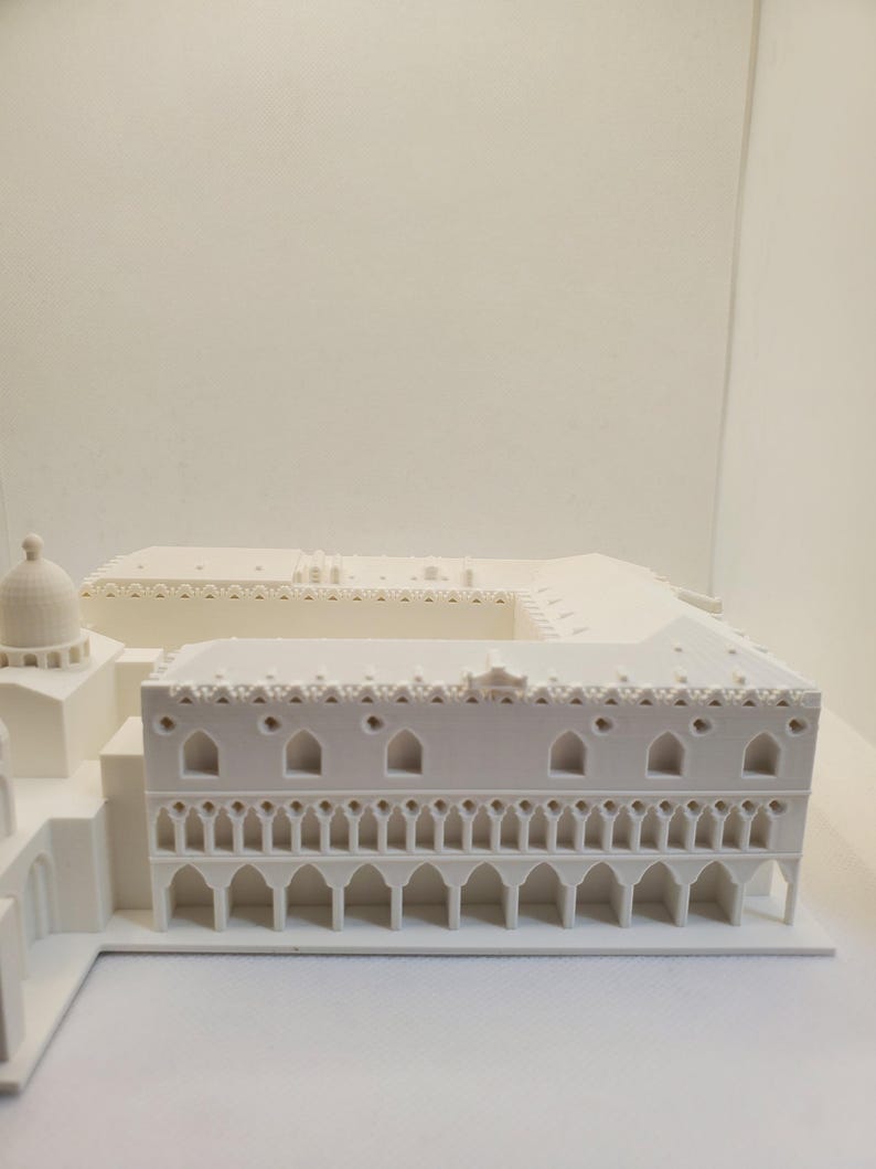 May include: A white 3D printed model of a building with a detailed facade and a domed roof.