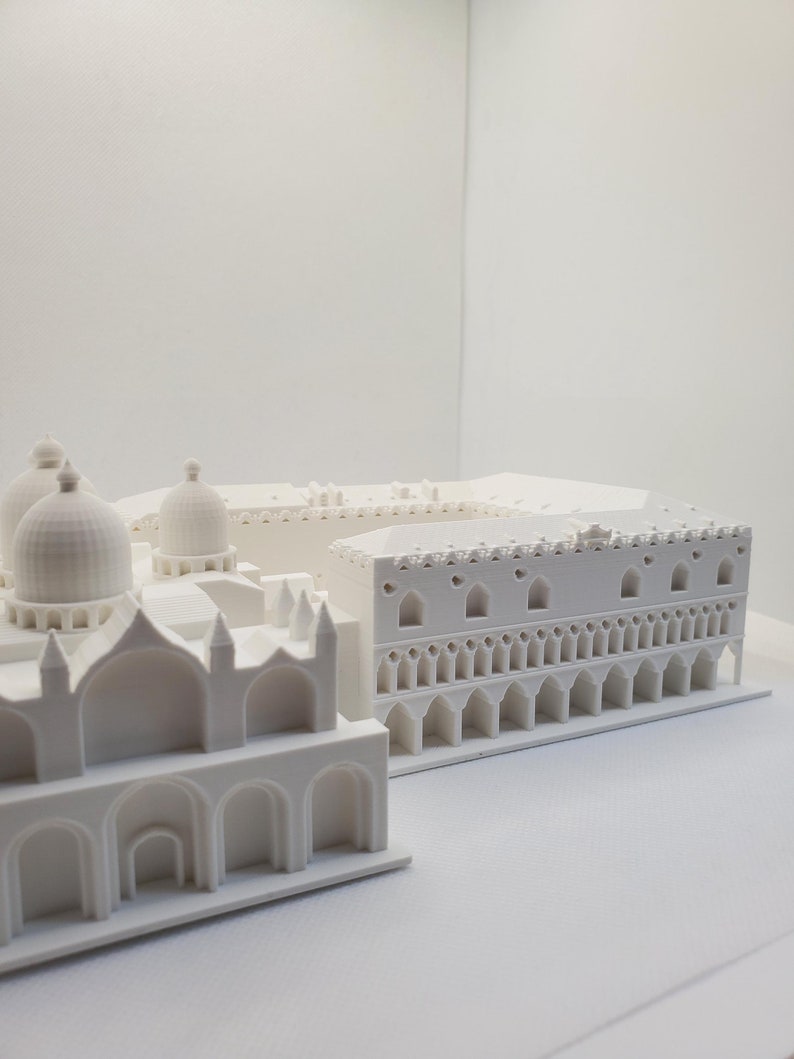 May include: A white 3D printed model of a building with a domed roof and a colonnade.