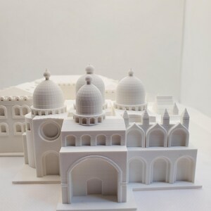 May include: White 3D printed model of a building with multiple domes and arches.