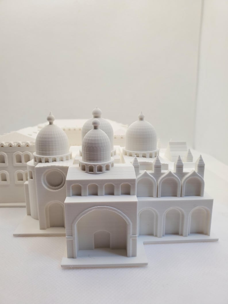 May include: White 3D printed model of a building with multiple domes and arches.