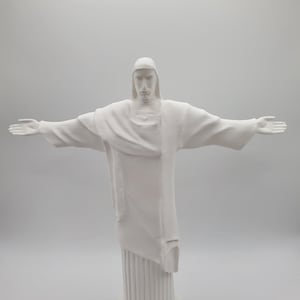 May include: White statue of Christ the Redeemer with outstretched arms, standing on a white base.