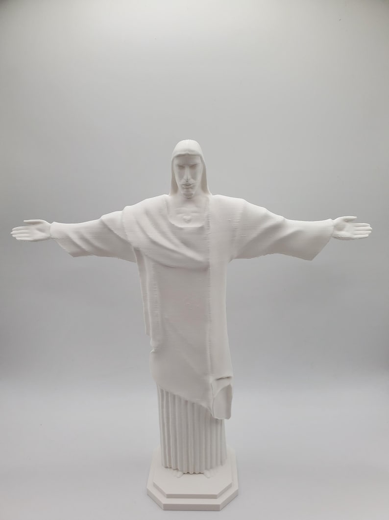 May include: White statue of Christ the Redeemer with outstretched arms, standing on a white base.