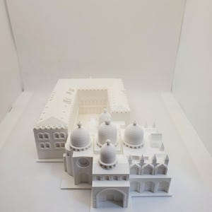 May include: A white 3D printed model of a building with multiple domes and arches. The model is detailed and intricate, showcasing the architectural features of the building.