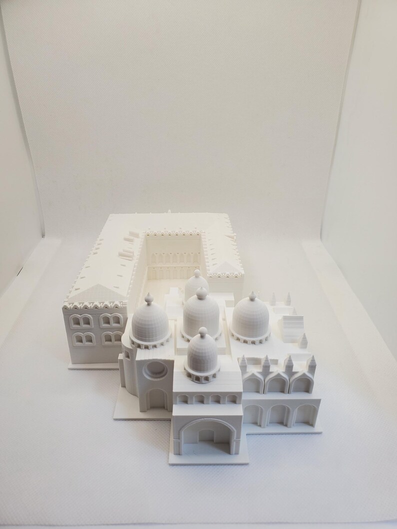 May include: A white 3D printed model of a building with multiple domes and arches. The model is detailed and intricate, showcasing the architectural features of the building.