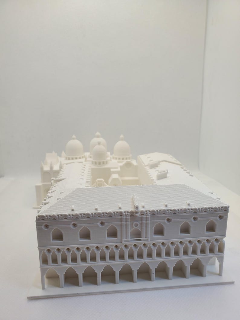 May include: White 3D printed model of a building with a domed roof and arched windows.