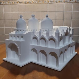 May include: A white 3D printed model of a building with multiple domes and arches. The model is detailed and intricate, showcasing the architectural style of the building.