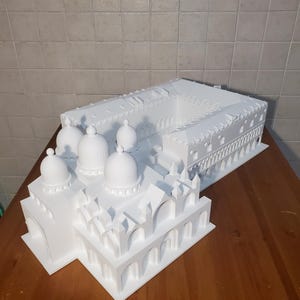 May include: A white 3D printed model of the Doge's Palace and St. Mark's Basilica in Venice, Italy.