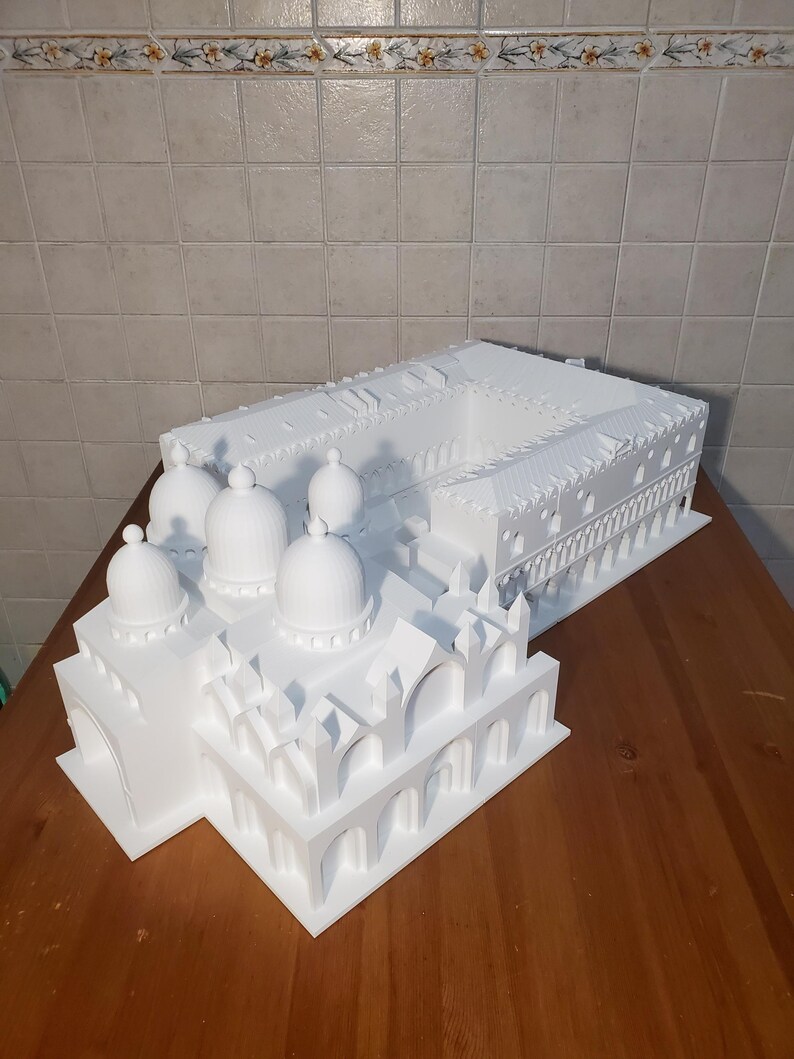 May include: A white 3D printed model of the Doge's Palace and St. Mark's Basilica in Venice, Italy.