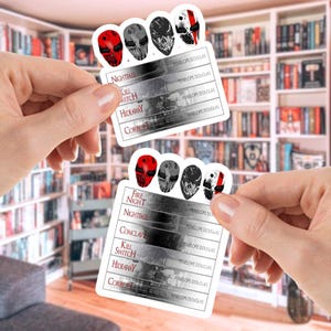 May include: Two rectangular stickers featuring a series of stylized skull designs in red, gray, and black. Each sticker has a list of book titles and the author's name, Penelope Douglas. The titles include "Nightfall," "Kill Switch," and "Hideaway."