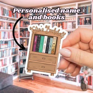 May include: A sticker featuring a cartoon bookshelf with the text "Katie's Bookshelf." The bookshelf is brown and filled with colorful book spines. The sticker also includes the text "Personalised name and books."