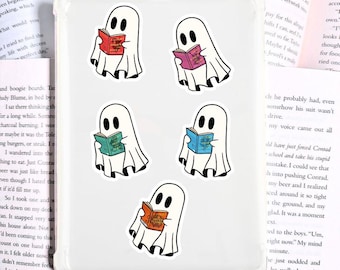 May include: Clear phone case with five white ghost stickers, each reading a different colored book. The ghosts have black eyes and are wearing white sheets. The books are red, purple, green, blue, and orange.