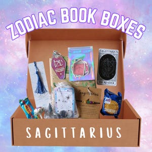 May include: A brown cardboard box filled with Sagittarius-themed items. The box contains a bookmark with a blue tassel, a keychain, stickers, a tarot card, a bracelet, a bag of crystals, and a package of cookies. The text "ZODIAC BOOK BOXES" and "SAGITTARIUS" are visible.