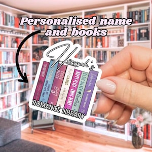 May include: A white sticker with the text "Hannah's Romance Library" and a stack of books with titles like "Heartless", "Happy Place", and "Icebreaker".