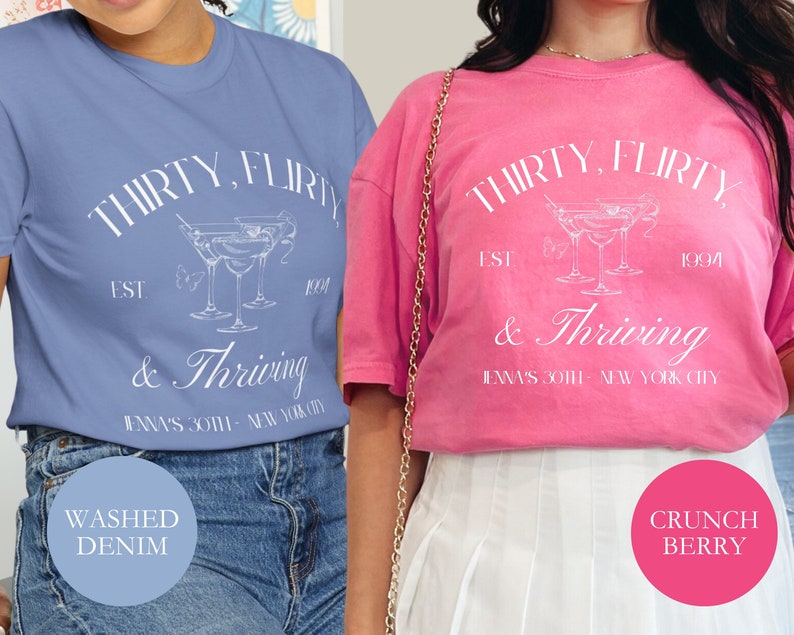 May include: Two women wearing t-shirts with the text "Thirty, flirty & thriving" and a graphic of a cocktail glass. The text also includes "Est. 1994" and "Jenna's 30th - New York City". One shirt is blue and the other is pink.
