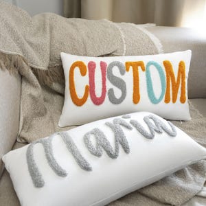 a white pillow with the word custom on it