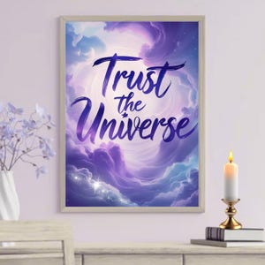 May include: A motivational quote, "Trust the Universe", is displayed in a purple and blue swirling font against a backdrop of clouds and stars. The quote is framed in a light wood frame.
