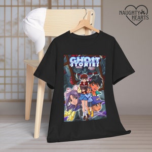 May include: Black t-shirt with a graphic print of the anime Ghost Stories. The graphic features a group of characters from the show, including a girl with purple hair and a boy with brown hair. The text "Ghost Stories" is printed in blue letters.