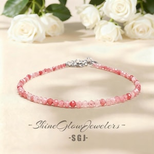 May include: A delicate pink gemstone bracelet with a silver clasp. The bracelet is composed of small, faceted beads in varying shades of pink. The text "-Shine Glow Jewelers- -SGJ-" is at the bottom.