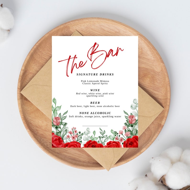 May include: A printable sign for a bar with the text "The Bar" in red script font. The sign lists signature drinks, wine, beer, and non-alcoholic options. The background features a watercolor design of red roses and green leaves.