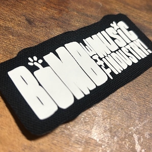 May include: Black fabric patch with white text that reads "Boomba Music Industry!"