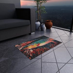 May include: A colorful area rug with a large, detailed illustration of a fish with orange, green, and blue scales. The fish is surrounded by red and orange flowers.