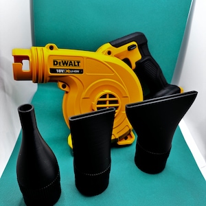 May include: A yellow and black cordless leaf blower with a DEWALT logo and 18V/XR LI-ION text. The blower comes with three black nozzle attachments.