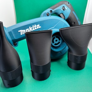 May include: Three black plastic nozzles for a Makita leaf blower. The nozzles are different shapes and sizes.