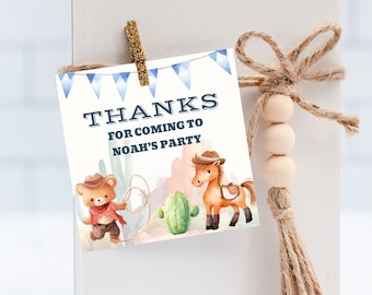 May include: A blue and white thank you tag with a cowboy theme. The tag features a cartoon bear wearing a cowboy hat and holding a lasso, and a cartoon horse wearing a saddle. The text on the tag reads "Thanks for coming to Noah's Party".
