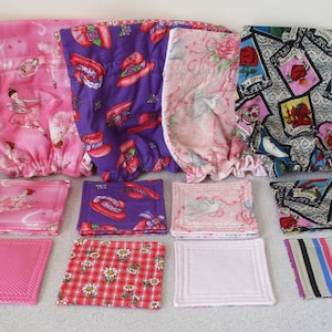 May include: A set of ten fabric squares in various patterns and colors, including pink, purple, red, and black. The squares are made of cotton and are perfect for quilting, crafts, or home decor.